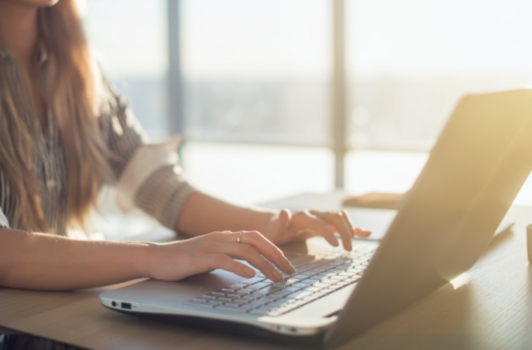 Woman typing on laptop computer