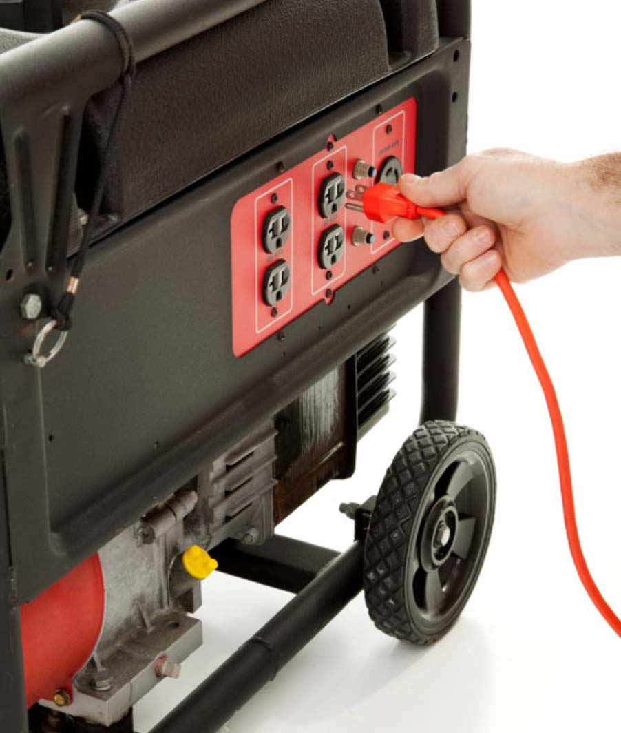 hand plugging cord into generator