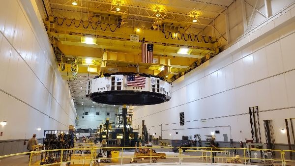 crane drops the final unit's stator into place