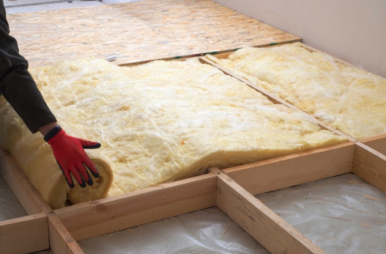 Hand installing new insulation