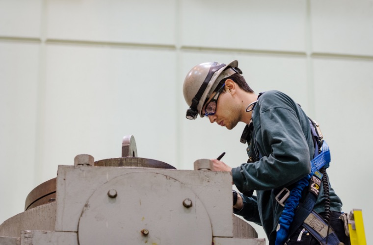 Student employee wearing hard hat and safety vest