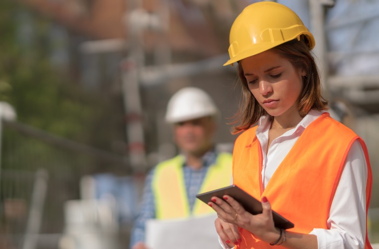 Student employee wearing hard hat and safety vest