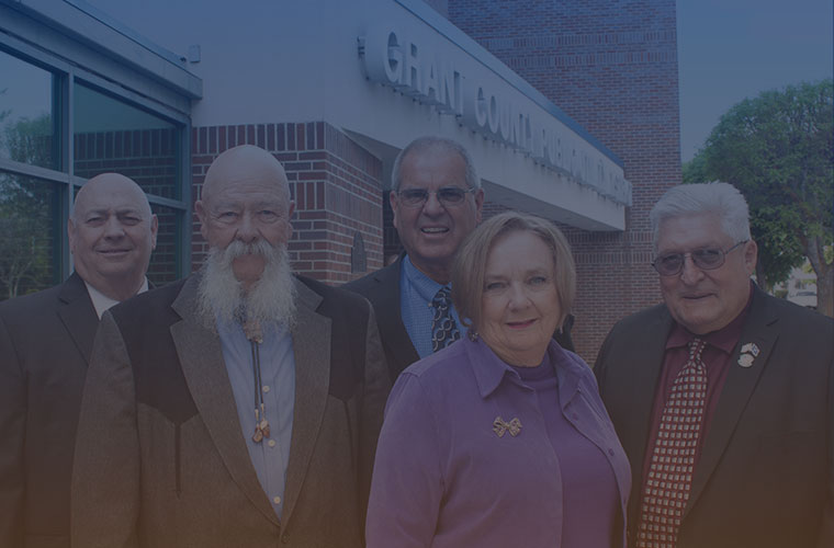 commissioners in front of headquarters building